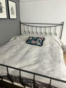a bed with a pillow on it in a bedroom at Graffiti Downtown Room in Szeged