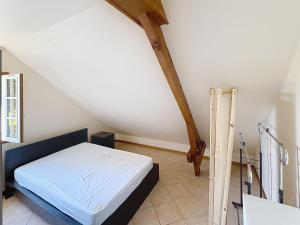 a bedroom with a bed in a attic at La Villa Santranges in Châtillon-sur-Loire