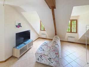 a living room with a fireplace and a chair at La Villa Santranges in Châtillon-sur-Loire +4 photos