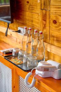 a group of glass bottles on a table with a telephone at Co To Victory Homestay in Chung Cap