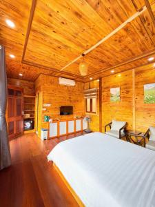 a bedroom with a large bed in a wooden room at Co To Victory Homestay in Chung Cap