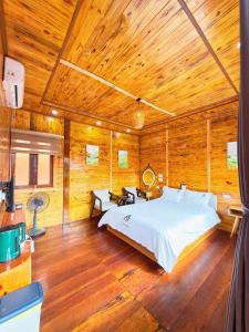a bedroom with a large bed in a wooden room at Co To Victory Homestay in Chung Cap +51 photos