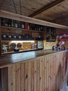 a bar in a cabin with a wooden wall at Chata Koszelanka in Nadkole