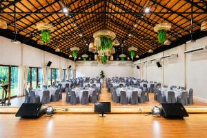 a large banquet hall with tables and chairs in it at Ranong Adventure Resort & Park in Ranong