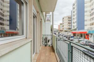 a balcony with a view of a city street at 2-bedroom Gem Central Odivelas in Odivelas