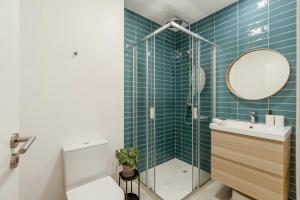 a bathroom with a toilet and a sink and a mirror at 2-bedroom Gem Central Odivelas in Odivelas +26 photos