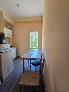 a small kitchen with a table and a chair at ОлександріЯ in Odesa