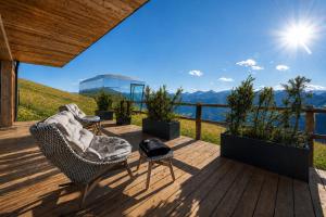 a deck with two chairs and a table with a view at Panorama Alm in Jochberg