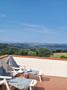a couple of chairs and a table on a balcony at Relax in Maremma tra Saturnia e Argentario in Pancole
