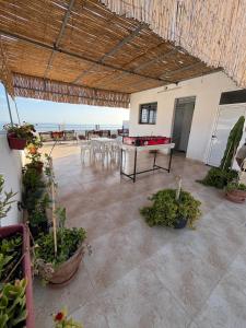 an outdoor patio with a ping pong table and chairs at Atlantic view Tamraght 3 in Tamraght Ou Fella