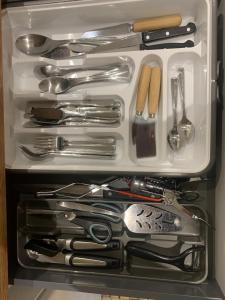 a drawer filled with lots of utensils at Gite VILLENEUVE LA COMTESSE in Villeneuve-la-Comtesse