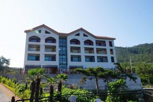 a large white building with trees in front of it at Byeonsanbando Jayjay Resort in Buan