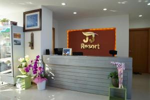 a reception desk in a restaurant with purple flowers at Byeonsanbando Jayjay Resort in Buan