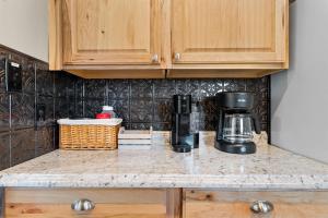 a kitchen counter with a coffee maker on a counter top at Austin's Hideaway Golf-view in Branson +23 photos