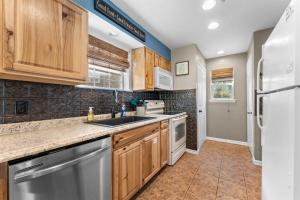 a kitchen with wooden cabinets and stainless steel appliances at Austin's Hideaway Golf-view in Branson