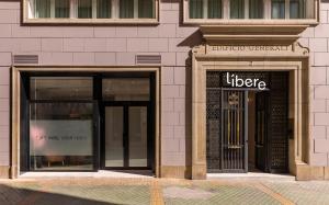 a store front with two windows and a door at Líbere Alicante Rambla in Alicante