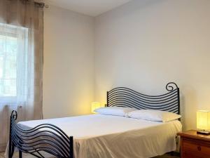 a bedroom with a bed with two chairs and a window at Allombra della quercia in Ortona