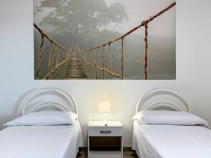 a suspension bridge painting in a bedroom with two beds at Allombra della quercia in Ortona