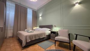 a bedroom with a bed and a desk and a chair at Apartment & Rooms Three Angels in Baška