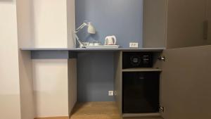a kitchen with a counter with a sink and a microwave at Apartment & Rooms Three Angels in Baška