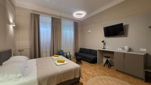 a hotel room with a bed and a couch at Apartment & Rooms Three Angels in Baška