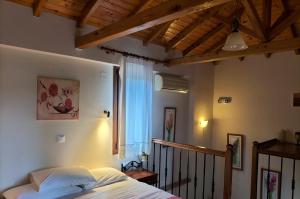 a bedroom with a bed and a window at Steni Vala Apartments in Steni Vala Alonissos