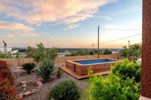 a backyard with a swimming pool and a fence at Trullo Petronella in Cisternino