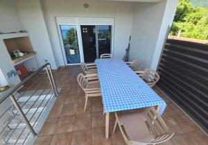 a blue table and chairs on a balcony at Vlad's Apartments in Larisa