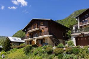 a house on a hill with a mountain at L'Edelweiss - Bouvier in Aillon-le-Jeune