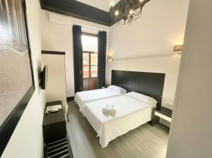 a bedroom with a white bed and a window at Alhambra Suites in Madrid +84 photos