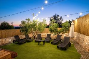 a group of chairs on a lawn with lights at Trullo Petronella in Cisternino