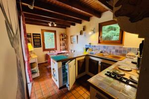 a kitchen with a sink and a counter top at Little Paradise hidden from view in Liézey