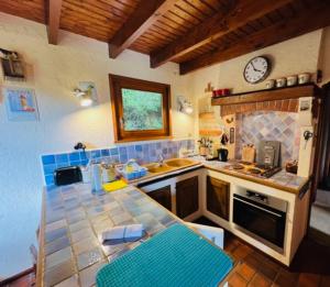 a kitchen with a counter and a clock on the wall at Little Paradise hidden from view in Liézey
