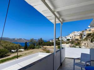 a view of the ocean from the balcony of a house at Palaios Rooms in Plaka Milou