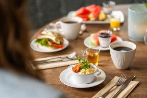a table with plates of food and cups of coffee at Aspenäs Herrgård in Lerum