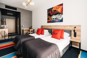 a hotel room with two beds and a painting on the wall at Hotel Polonez in Krakow