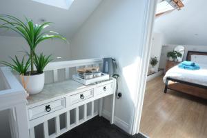 a bedroom with a white dresser with plants on it at Steps to the Sand in Melcombe Regis