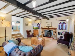 a living room with a couch and a fireplace at The Coach House Dulverton in Dulverton