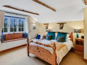 a bedroom with a large bed and a window at The Coach House Dulverton in Dulverton