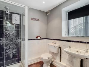 a bathroom with a toilet and a sink at The Coach House Dulverton in Dulverton +9 photos