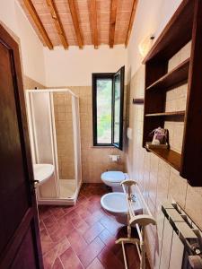 a bathroom with two toilets and a shower at Il Casolare Val Di Mare in Riparbella +44 photos
