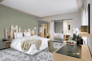 a bedroom with a large white bed and a desk at Domaine de l'éclaircie in Saint-Quirin
