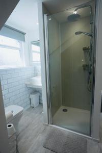 a bathroom with a shower and a toilet at Steps to the Sand in Melcombe Regis