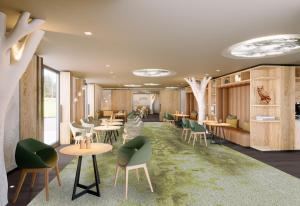 a waiting room with tables and green chairs at Domaine de l'éclaircie in Saint-Quirin