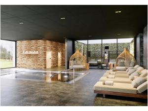 a living room with couches and chairs in a building at Domaine de l'éclaircie in Saint-Quirin