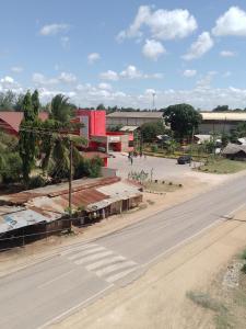an empty street in a town with a building at Reenhomes in Kilifi