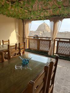a dining room with a table with a view of a mosque at Nabibek boutique in Bukhara
