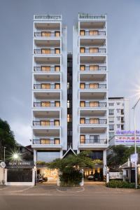 a tall white apartment building with windows at WH302 Residence by WH in Phnom Penh