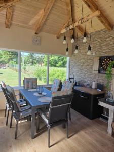 a kitchen and dining room with a blue table and chairs at House4Seasons in Lič