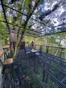 a woman standing on the deck of a tree house at Villa Concepcion Staycation by ngb in Real +7 photos
